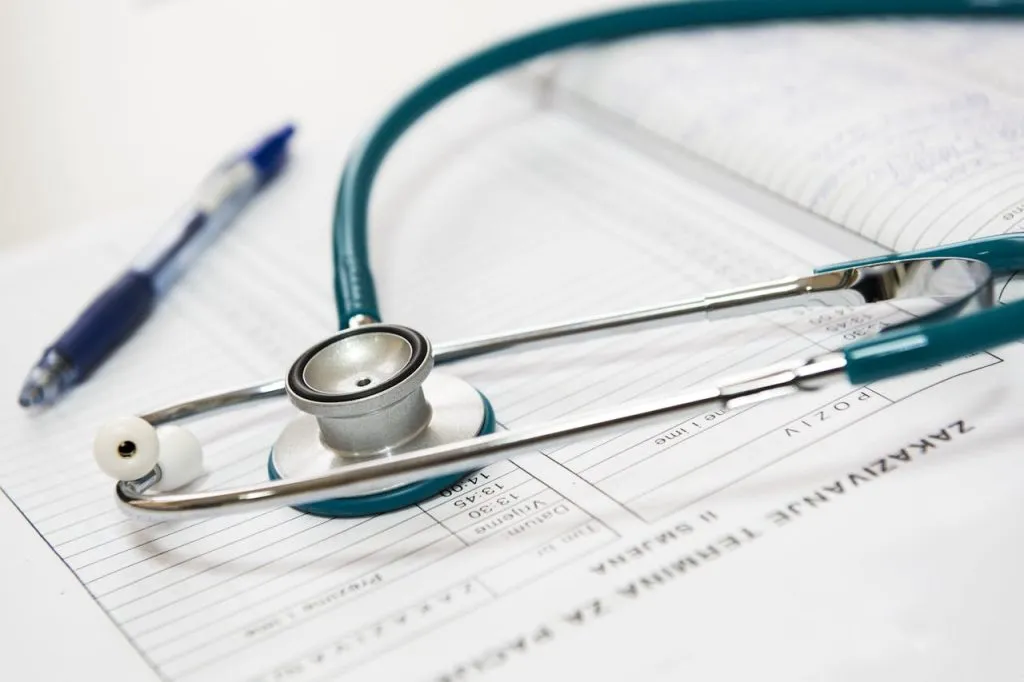 Stethoscope and pen resting on a medical form