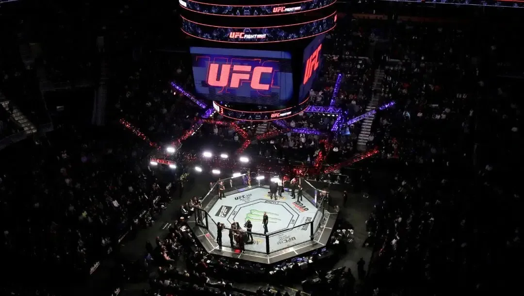 Aerial view of a UFC cage in a darkened arena during an event