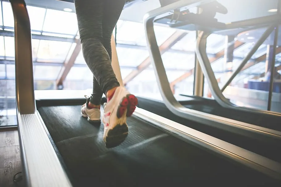 Close-up of a person's legs running on a treadmill