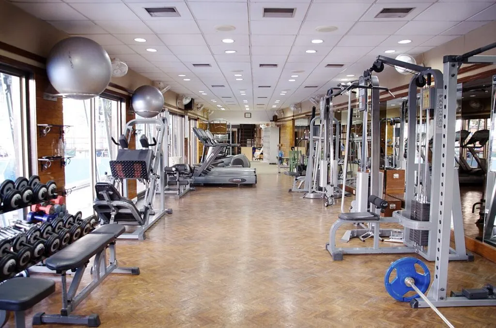 Empty weights gym with racks, benches and cable machines