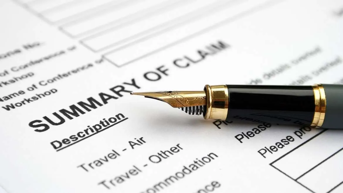 Fountain pen resting on a form headed Summary of Claim