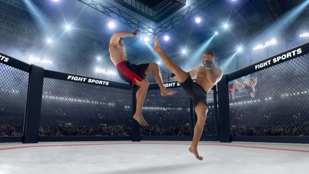Two MMA fighters trading kicks in an arena cage under stadium lights